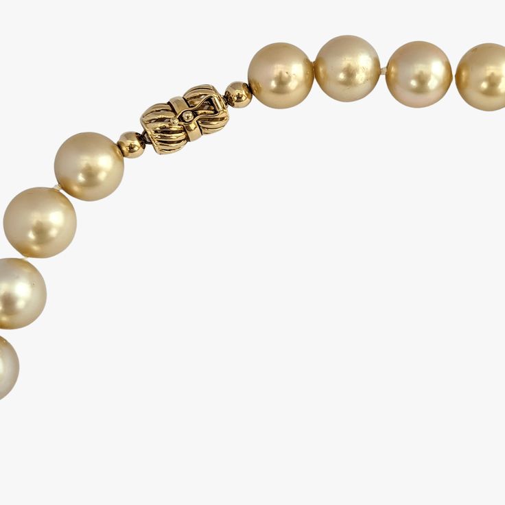 Indulge in the elegance and natural beauty of this stunning South Sea pearls necklace, featuring cultured Golden South Sea pearls sourced from Indonesia. Crafted with meticulous attention to detail, this necklace is a testament to exceptional craftsmanship and exquisite materials. Secured with a 14K yellow gold 'twist and lock' clasp, the necklace measures 17.25 inches (43.5cm) in length, draping gracefully around the neckline. The weight of 95.7g adds a substantial feel and underscores the luxu Luxury Pearl Necklace With 17 Jewels, Elegant Round Pearl Necklace With High Luster, Formal Pearl Necklace With Polished Beads, Elegant High Luster Pearl Necklace, Luxury Single Strand Yellow Gold Pearl Necklace, Elegant Polished Beads Jewelry For Evening, Luxury Jewelry With Round Beads For Evening, Elegant Polished Bead Jewelry For Evening, Elegant Formal Pearl Necklace With High Luster