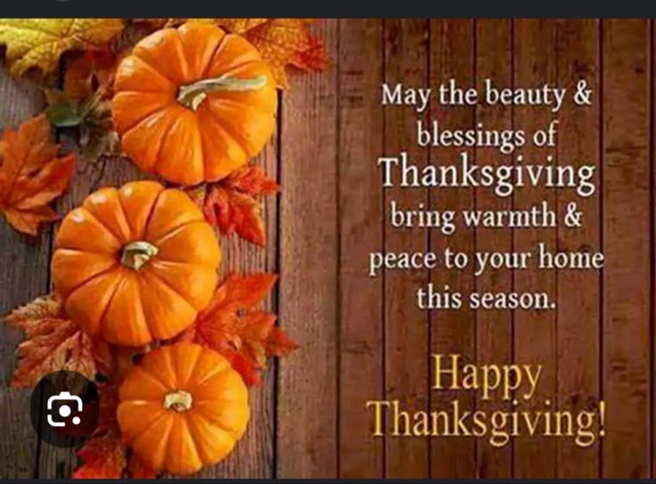 happy thanksgiving card with pumpkins and leaves on wooden background, text reads may the beauty & blessing of thanksgiving bring warm and peace to your home this season