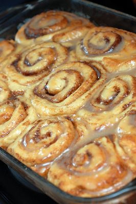 cinnamon rolls are being baked in a glass baking dish