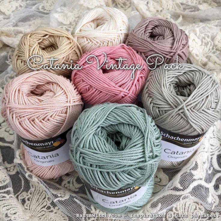 several balls of yarn sitting on top of a lace covered tablecloth with the words, gaia vintage lace