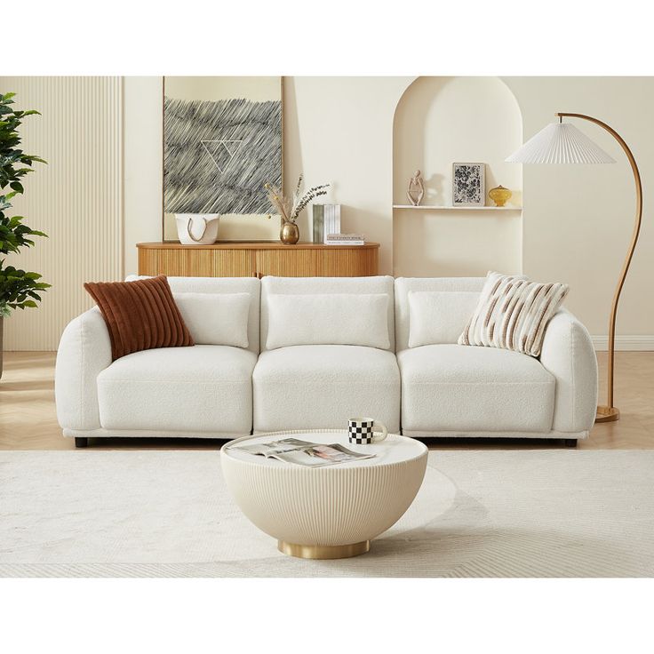 a living room with a white couch and coffee table