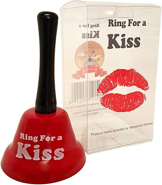 a red bell with the words ring for a kiss written on it and a plastic package