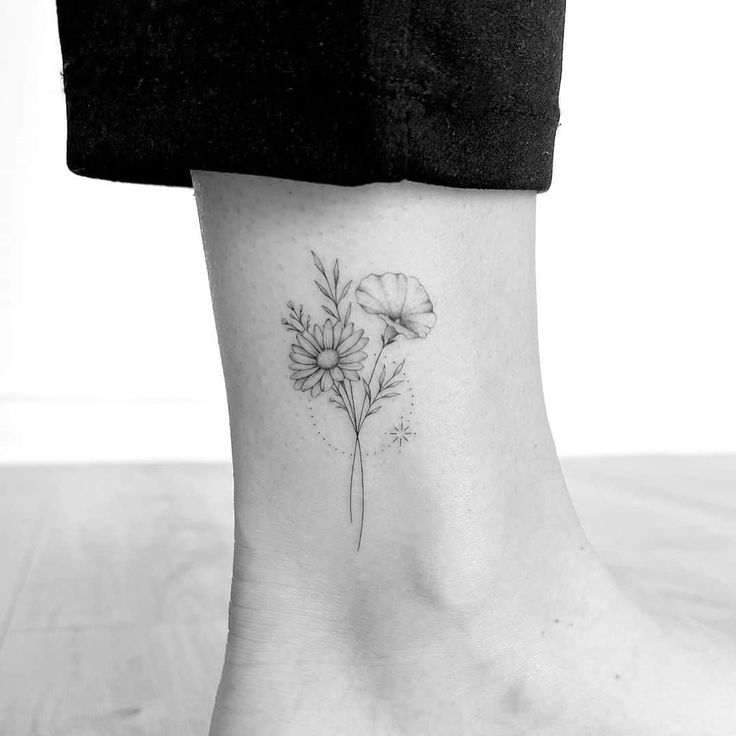 a black and white photo of a flower on the ankle