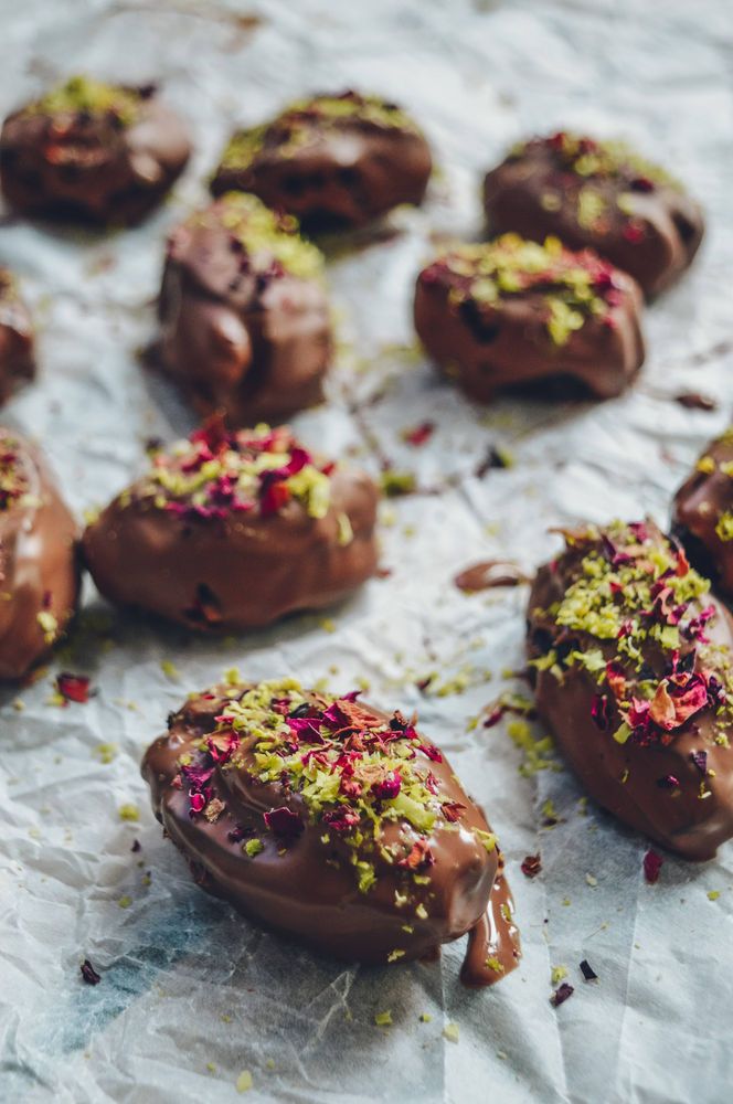 chocolate covered donuts with sprinkles and nuts