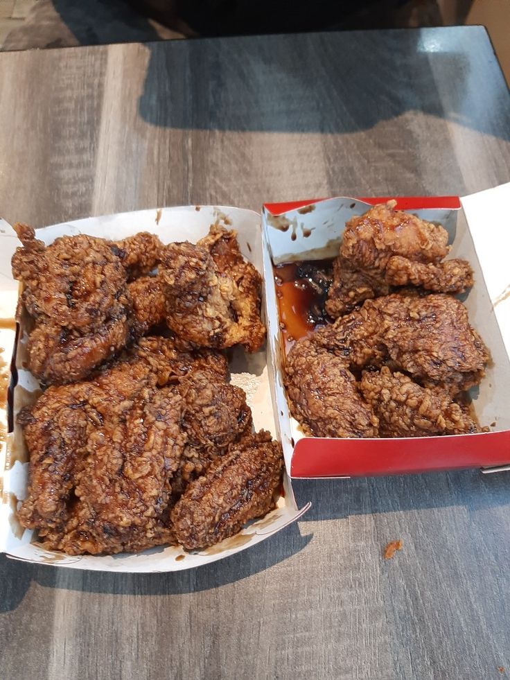 two trays of food sitting on top of a table