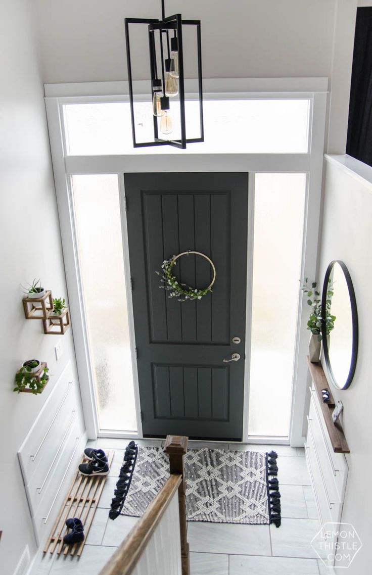 an overhead view of a front door with a wreath on the door and two mirrors