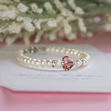 Oh so beautiful bracelet for little girls with blush pink Swarovski crystal heart beadStretch freshwater pearl bracelet, 5Heirloom Collection Sparkling accentsBoxed Adjustable Heart-shaped Crystal Bracelet For Weddings, Elegant Heart Charm Bracelet For Birthday, Elegant Heart Bracelet With Charm For Birthday, Heart-shaped Pearl Bracelet For Wedding, Mother's Day Beaded Pearl Jewelry, Wedding Pearl Bracelet With Heart Beads, Adjustable Pearl Heart Bracelet As Gift, Pearl Heart Bracelet For Gift, Adjustable Pearl Bracelets With Heart Charm