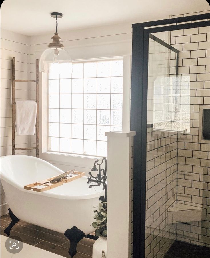 a white bath tub sitting next to a window