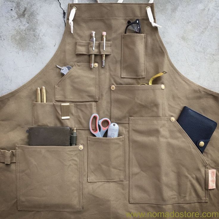 a brown apron with some scissors and other items in pockets on the front side