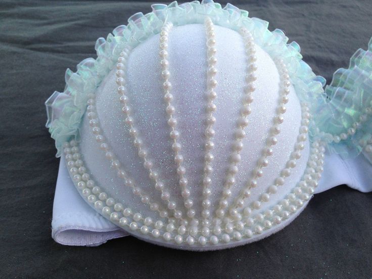 there is a white shell with pearls on it