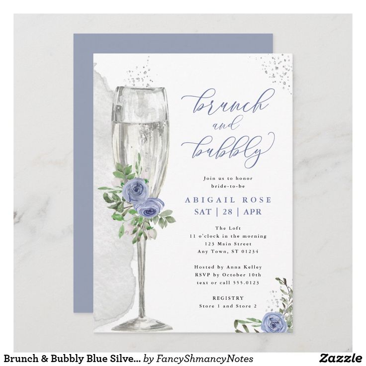 a blue and white wedding card with two champagne glasses on the front, one is filled with flowers