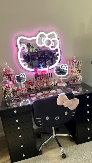 a desk with a hello kitty mirror on it