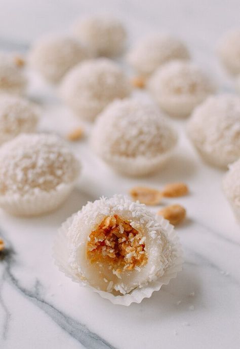 some kind of dessert that is sitting on a marble counter top with nuts scattered around it