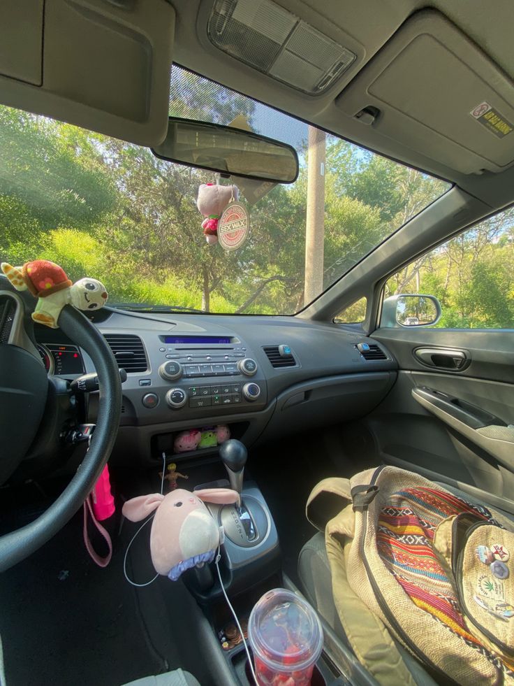 the interior of a car with stuffed animals and toys in the passenger's seat