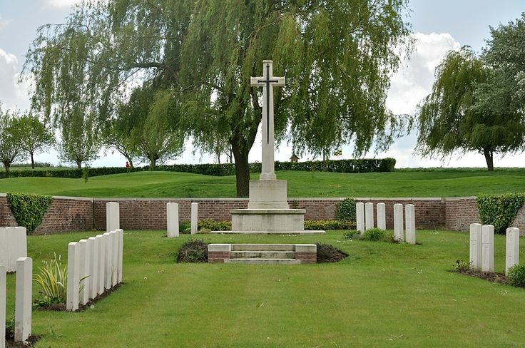 a cemetery with several crosses in the grass