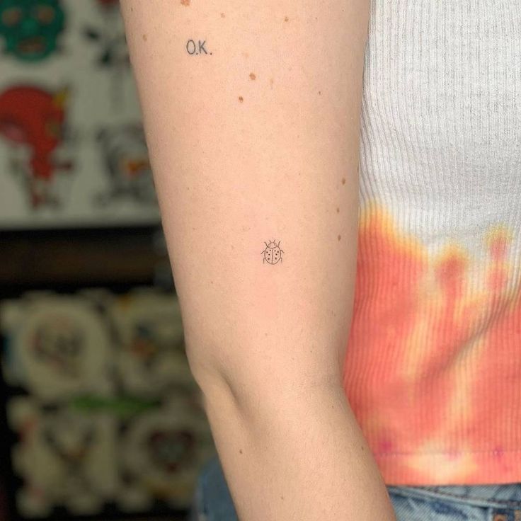 a woman with a small tattoo on her arm