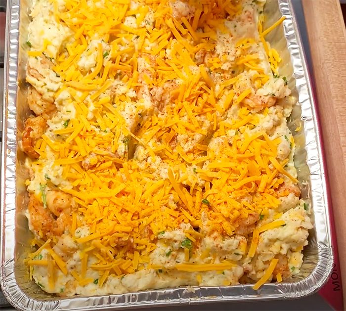 a casserole dish with chicken and cheese on top