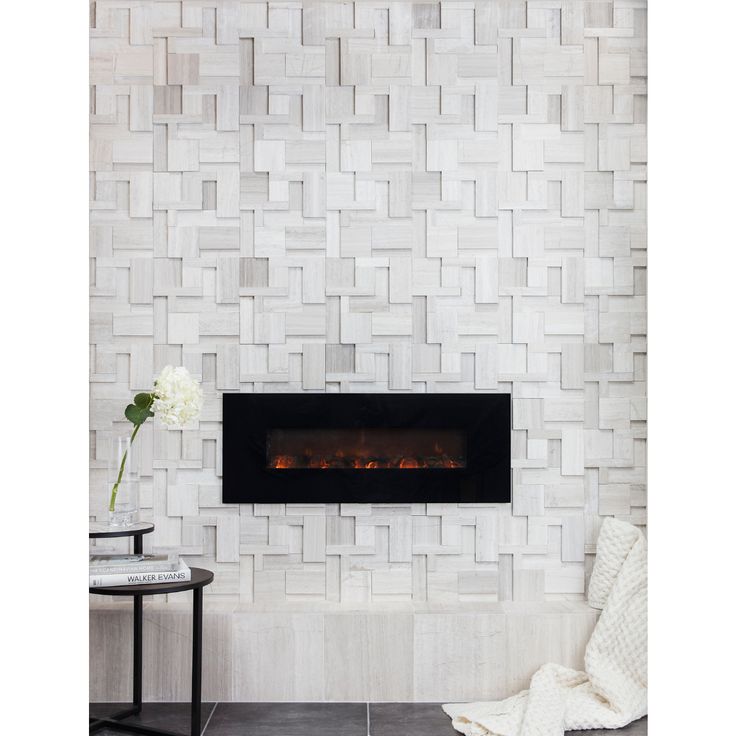 a living room with a white brick wall and a fire place in the fireplace,