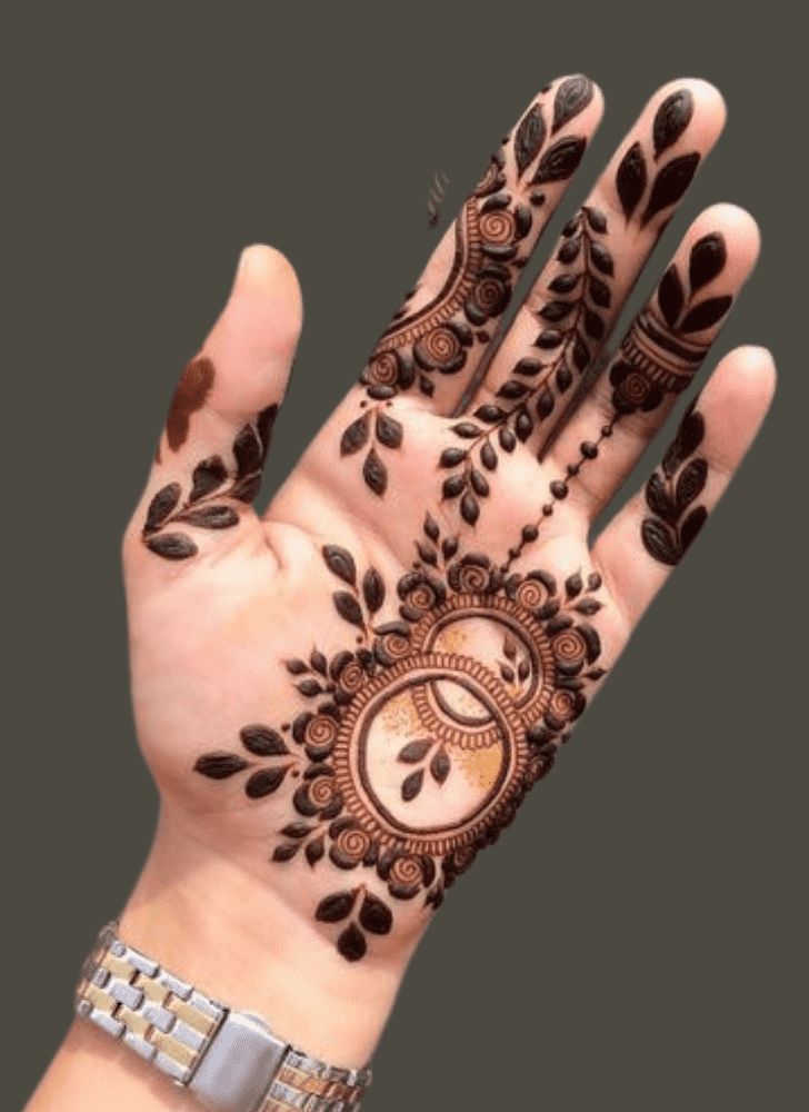 a hand with henna on it and some flowers in the middle of its palm