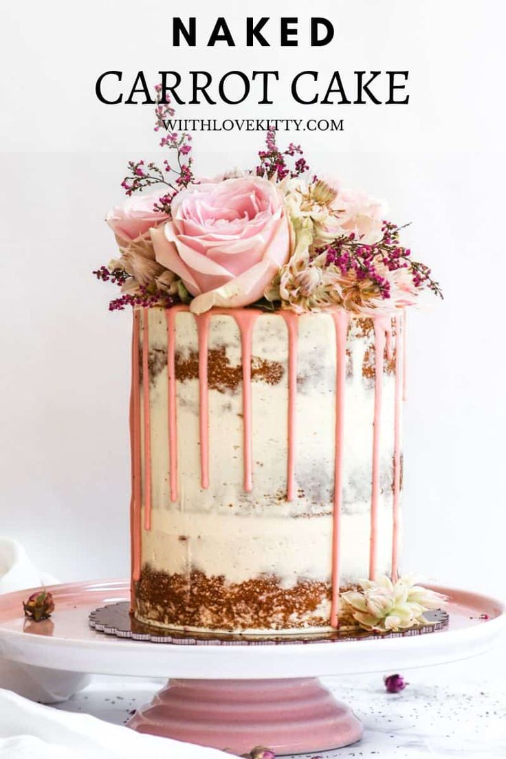 a white cake with pink icing and flowers on top