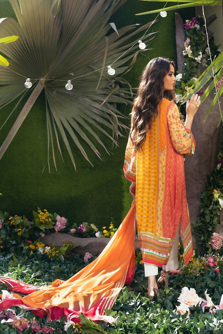 Created in the house at the Amna Arshad Design House. A straight relaxed silhouette fit for all occasions with a burst of colors and prints making it a festive must-have! Wear it on Iftar Eid or Mayuns it's a versatile outfit very close to our hearts. Printed on pure crepe silk to give you that luxurious feel. Dupatta is two-toned tissue silk with signature gotta detailing. The shirt has multiple handworks and gotta detailing with pants complete the look. Festive Bohemian Kurta With Vibrant Print, Festive Multicolor Lawn Suit For Summer, Traditional Festive Sets With Vibrant Print, Bohemian Orange Sets With Printed Motifs, Printed Lawn Suit For Festivals, Traditional Orange Floral Print Kurta, Eid Orange Floral Print Sets, Spring Multicolor Mulmul Lawn Suit, Orange Floral Print Sets For Eid