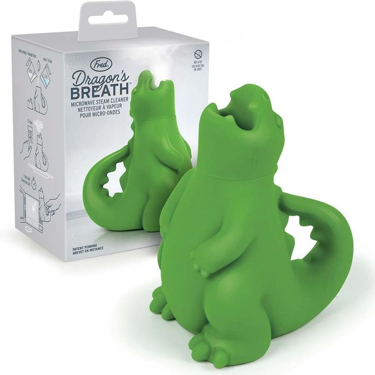 two green alligator shaped toothbrushes in front of a box