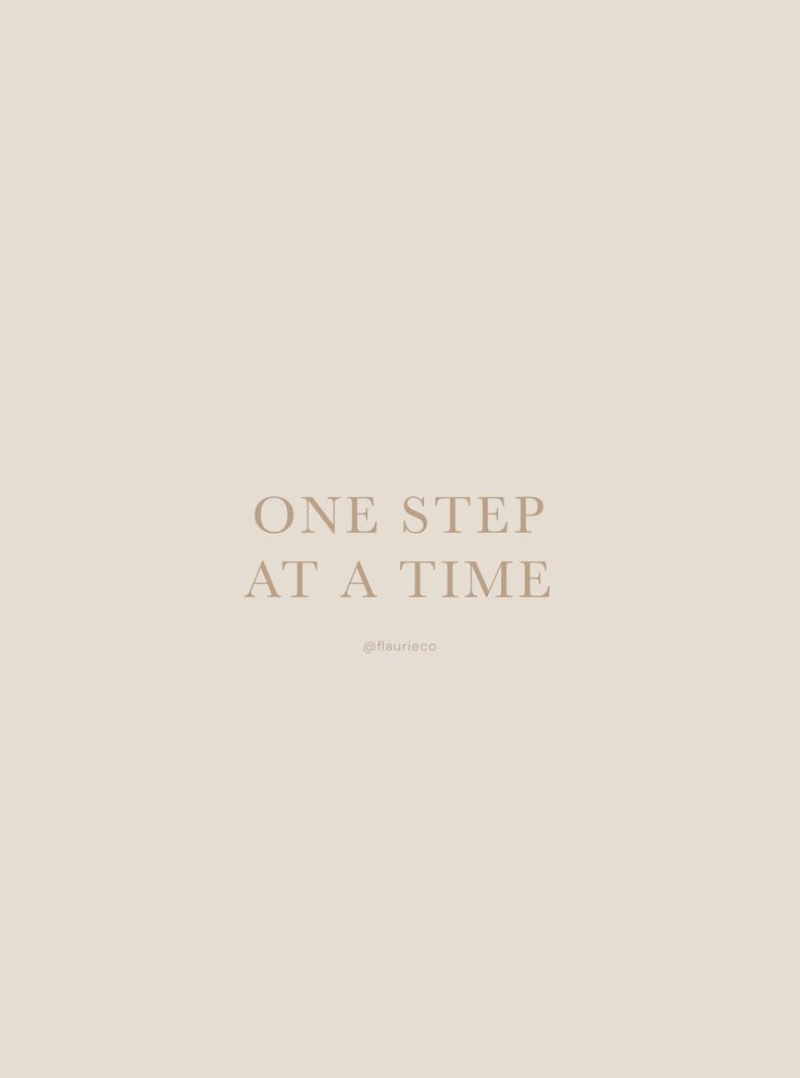 the words one step at a time are written in white on a beige background with a black