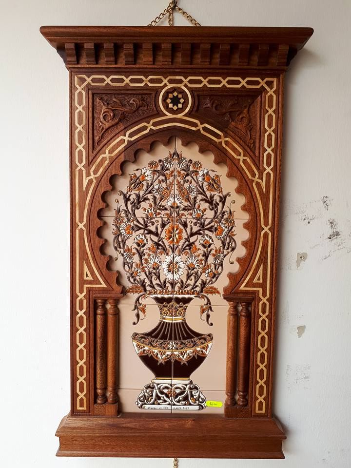 an ornate wooden clock hanging on the wall