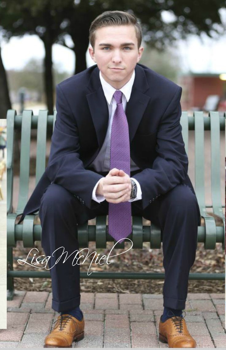 a man in a suit and tie sitting on a bench