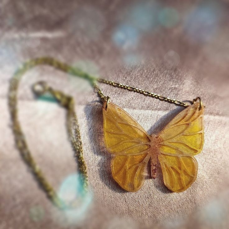 A butterfly pendant in sunset golds and oranges. Bohemian Butterfly Necklace For Gifts, Bohemian Butterfly Necklace As A Gift, Handmade Gold Bohemian Butterfly Necklace, Orange Butterfly-shaped Jewelry Gift, Gold Bohemian Butterfly Necklace, Orange Butterfly Jewelry Gift, Orange Butterfly Jewelry For Gifts, Handmade Gold Butterfly Necklace, Sunset Butterfly