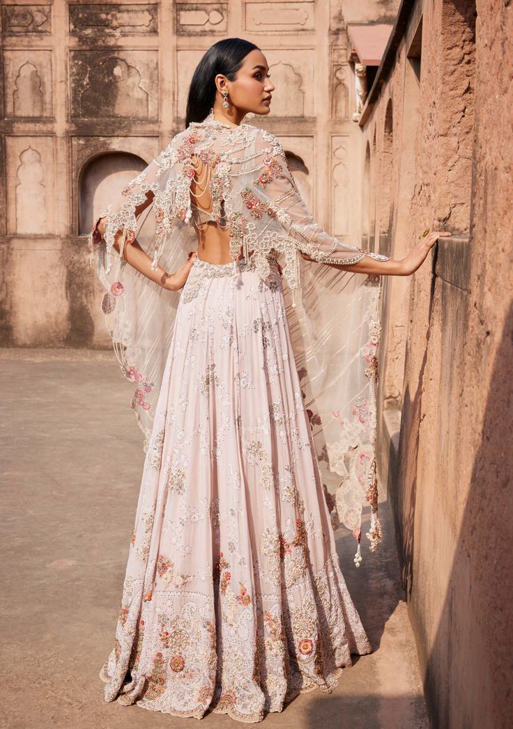 Presenting an off-white Chikankari mukaish lehenga adorned with pearl and zardozi hand embroidery. Paired seamlessly with a sheeted crystal bustier choli and an organza cutwork border-embroidered dupatta. This ensemble exudes timeless elegance, combining traditional craftsmanship with modern flair. Organza Cutwork, Cape Set, Simple Frocks, Embroidered Lehenga, Embroidered Dupatta, Fashionista Clothes, Cut Work, Lehenga, Hand Embroidery