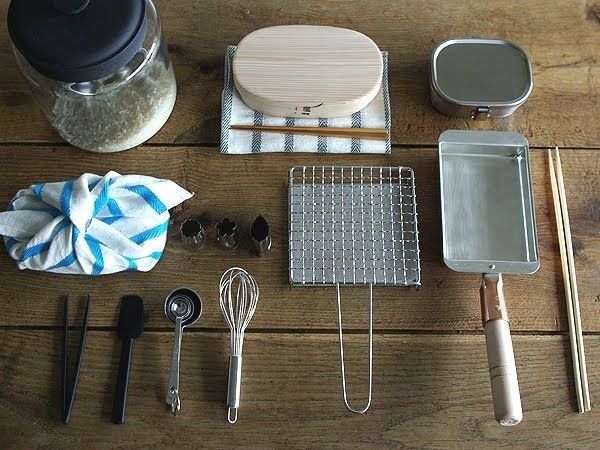 various kitchen utensils are laid out on a table