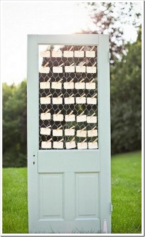 a white door sitting on top of a lush green field