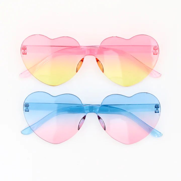 A two pack of cute heart sunglasses in a pink to yellow and turquoise to pink ombré. Adult sized. Trendy Rainbow Sunglasses With Gradient Lenses, Multicolor Heart-shaped Sunglasses With Gradient Lenses, Trendy Multicolor Heart-shaped Sunglasses, Heart-shaped Multicolor Sunglasses With Gradient Lenses, Rainbow Sunglasses With Uv Protection For Summer, Playful Heart-shaped Sunglasses With Gradient Lenses, Fun Summer Sunglasses With Heart Print, Cute Heart Shaped Sunglasses For Spring, Cute Heart-shaped Sunglasses For Spring