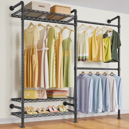 an organized closet with clothes and shoes hanging on the rack, next to a wall mounted shoe rack