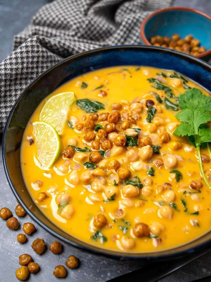 a bowl filled with chickpeas and garnished with cilantro