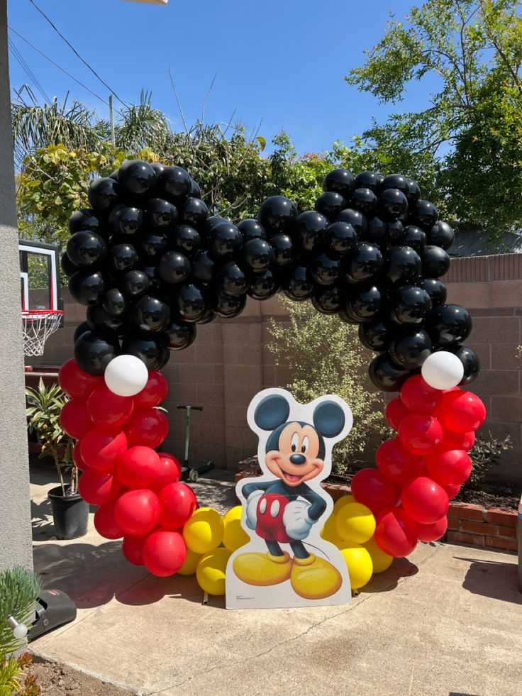 mickey mouse balloon arch with black and red balloons