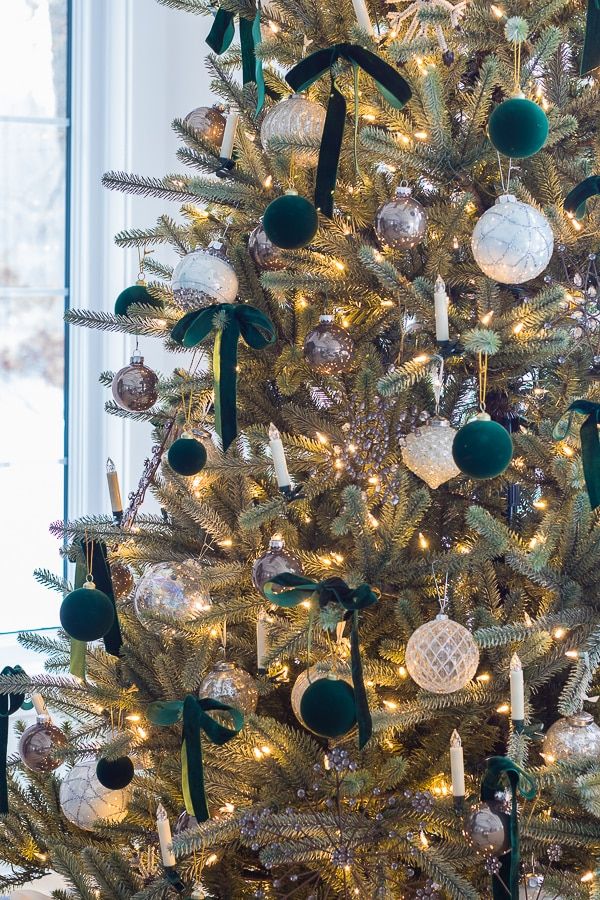 a decorated christmas tree with green and white ornaments