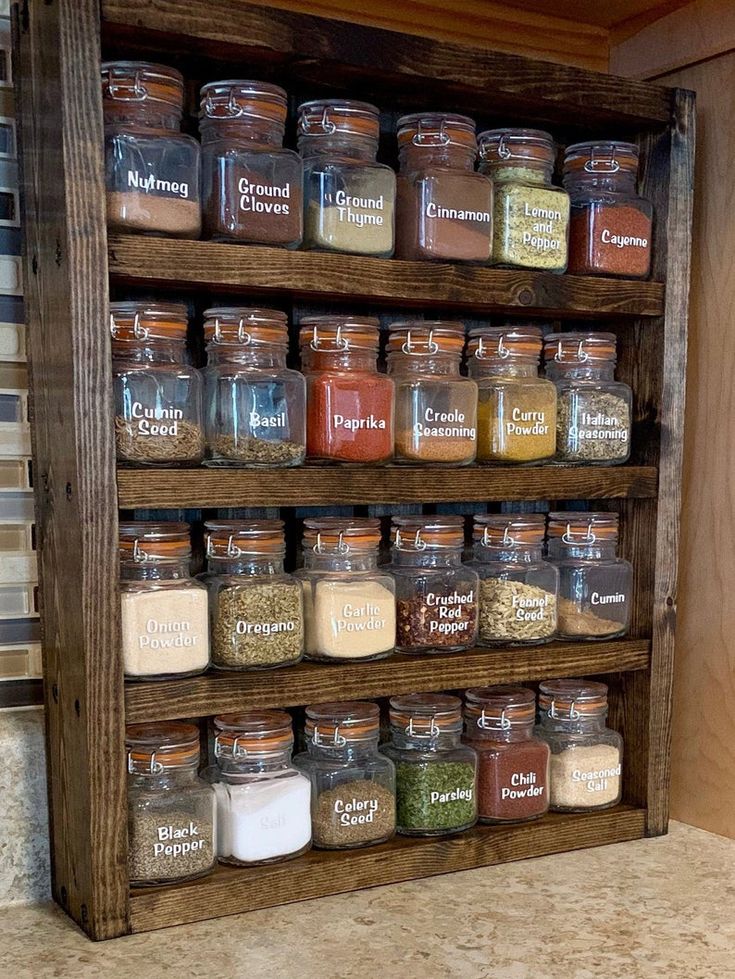 a wooden spice rack filled with lots of different types of spices