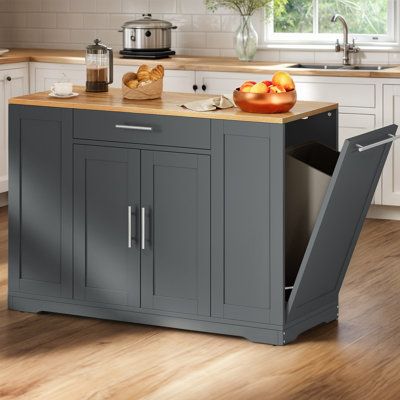 a kitchen island with an open door on the side and some fruit in front of it