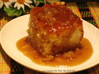 a piece of cake sitting on top of a white plate covered in caramel sauce