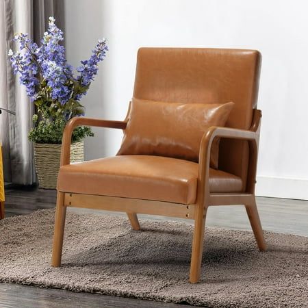 a brown leather chair sitting on top of a rug next to a vase with purple flowers