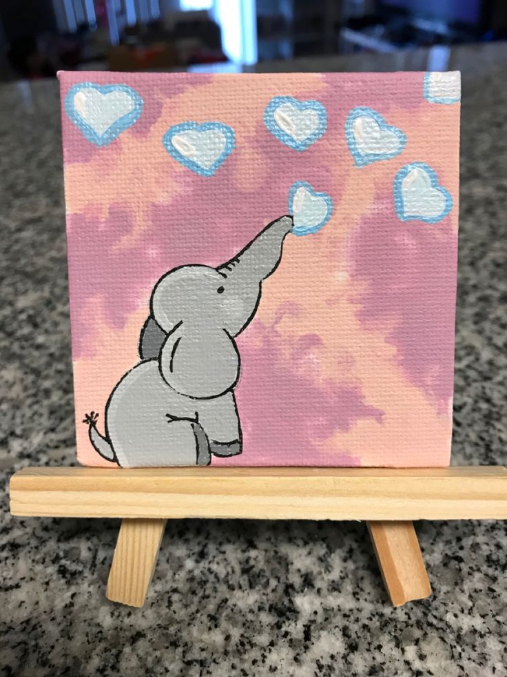 an elephant is painted on a pink and blue background with hearts in the shape of clouds