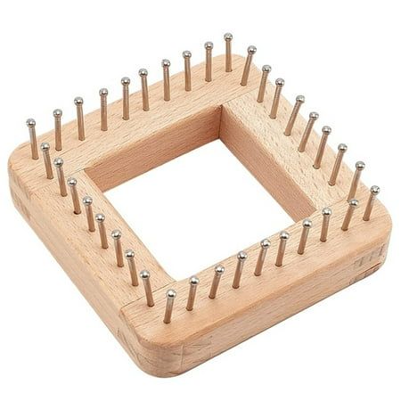 a wooden square with many pins in it