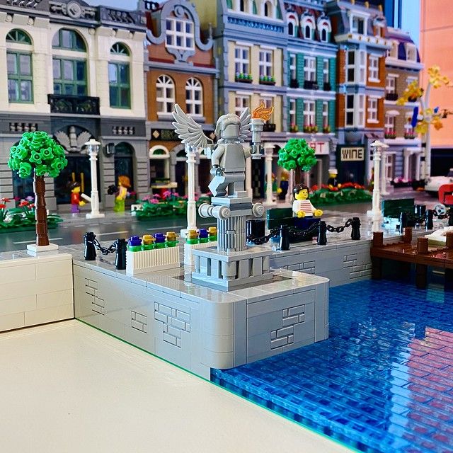 there is a lego model of a boat in the middle of a city with buildings