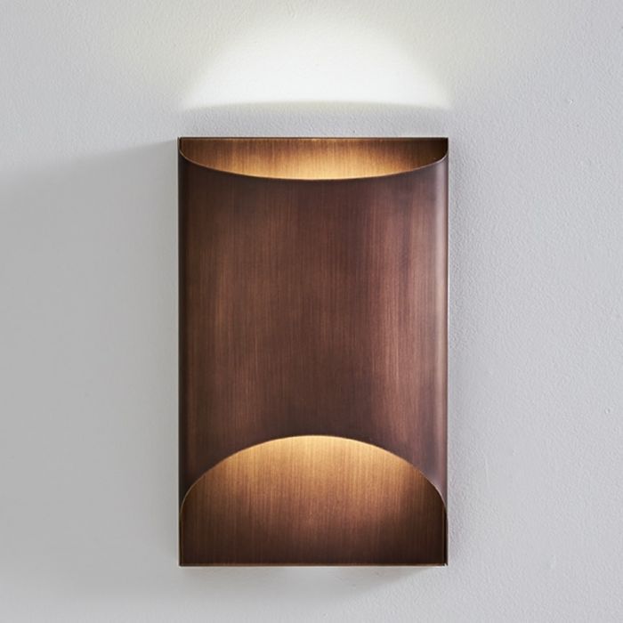 a wall light mounted on the side of a white wall