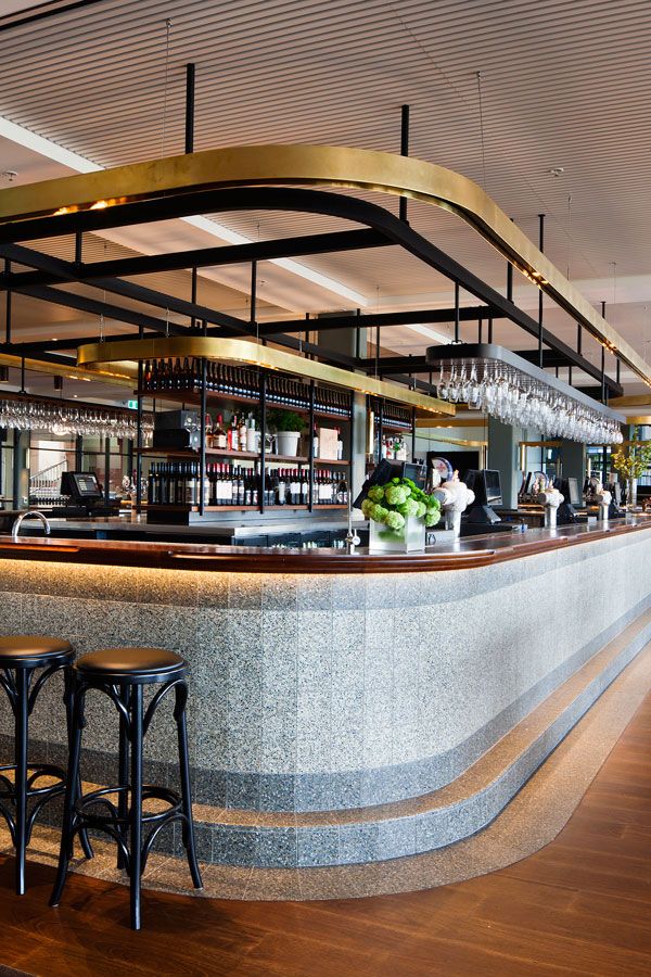 an empty bar with three stools in front of it