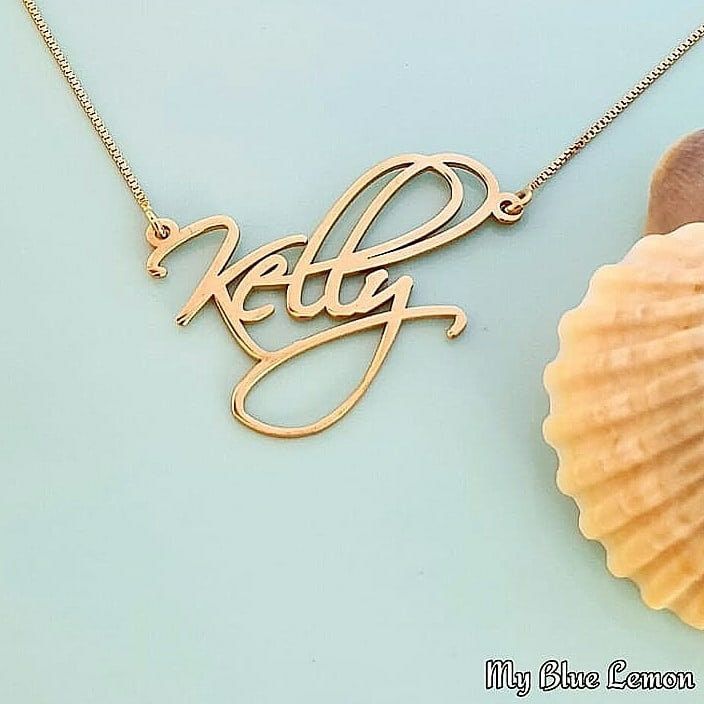 Order any name for your solid 14K gold Kelly Artistic style nameplate necklace!! A great personalized custom made gift for any occasion!! Birthday, Graduation or Any Holiday! *Both the nameplate and chain are all solid 14k gold. *Stamped for authenticity 14K (Hallmarked 14k) *Nameplate is 0.9 mm high quality thickness. *Font is larger than my other fonts, the capital will be approximately 1.3 cm tall *This listing is for one (1) name with one (1) capital letter only! Maximum is 9 letters. 10 or Signature Gold Jewelry With Initials, Gold Signature Jewelry With Initials, Customizable Yellow Gold Name Necklace For Anniversary, Customized Signature Nameplate Necklace, Elegant Customized Name Necklace For Anniversary Gift, Elegant Engraved Name Necklace For Anniversary Gift, Customizable Elegant Name Necklace For Anniversary, Gold Custom Name Necklace For Anniversary, Custom Name Gold Necklace For Anniversary