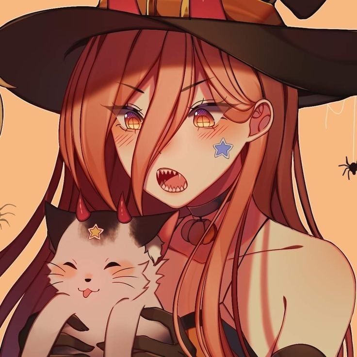 a woman in a witches hat holding a cat