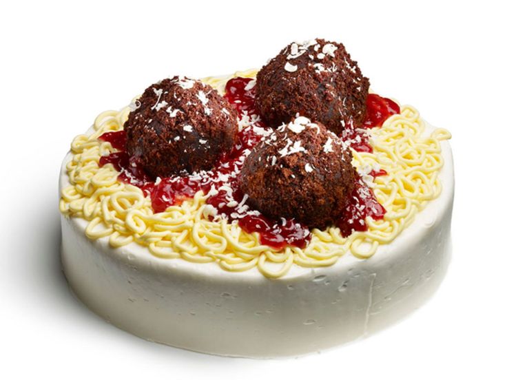 a white plate topped with cake covered in frosting and cranberry toppings